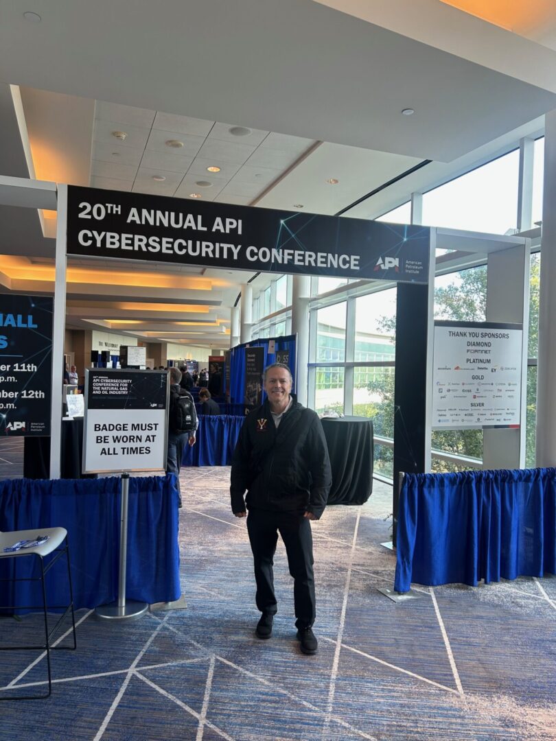 Man standing in front of the 20th Annual API Cybersecurity Conference banner.