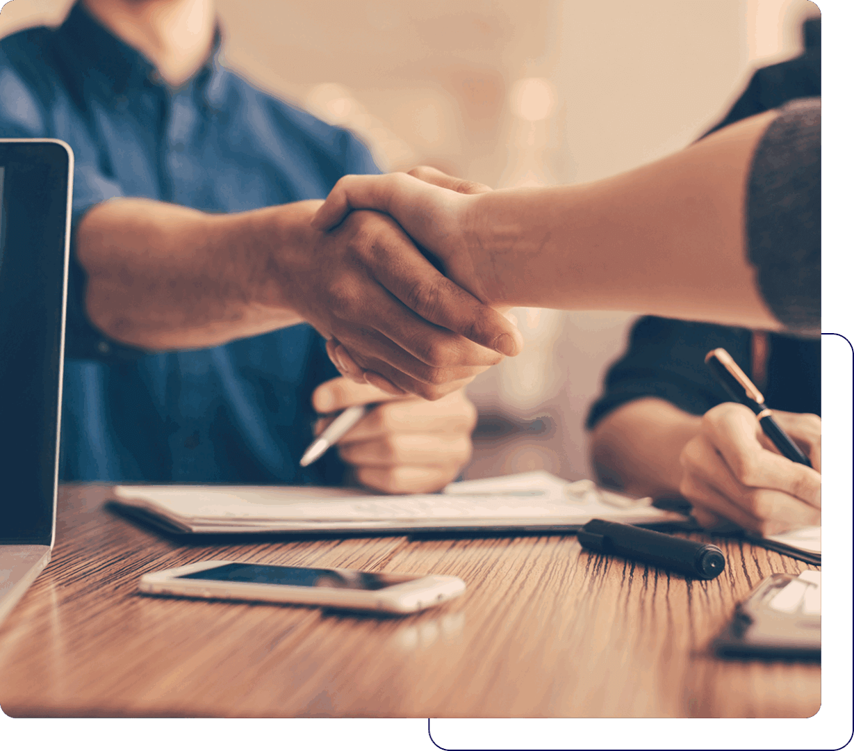 Two people shaking hands in agreement.